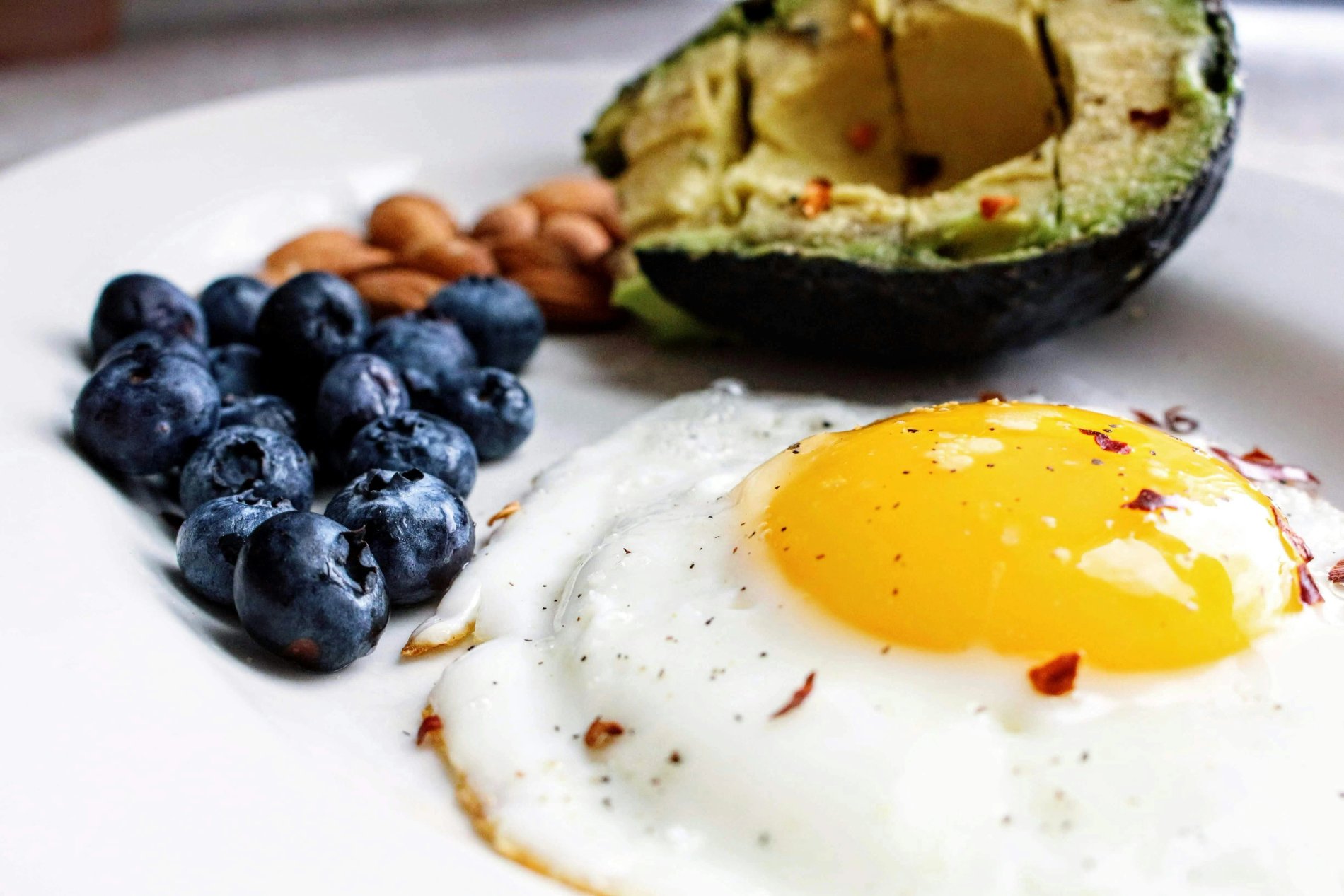 Good fats foods like salmon avocado and nuts versus bad fats like butter and fried food